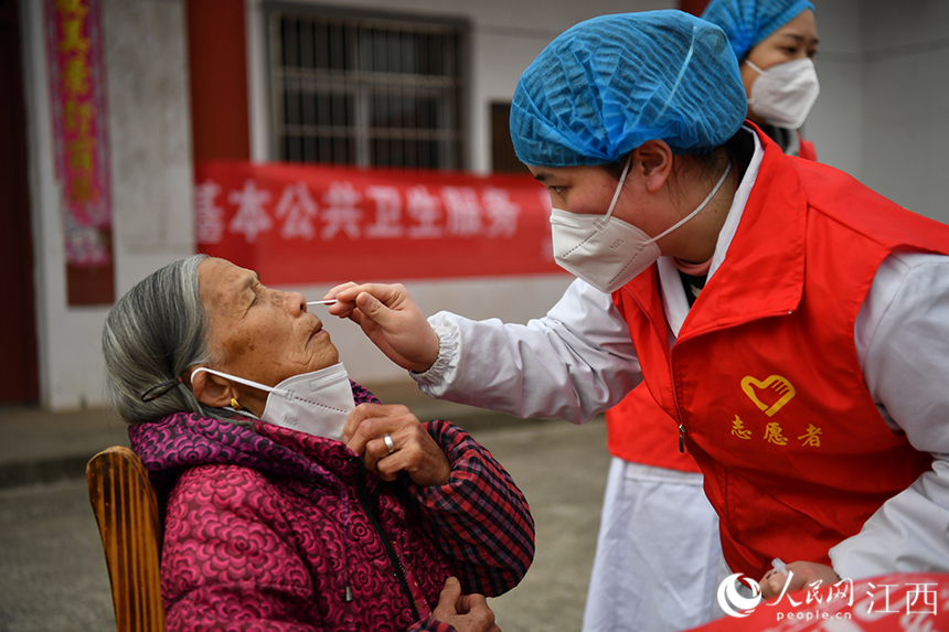 社區(qū)衛(wèi)生服務(wù)中心的醫(yī)生為村民做抗原檢測。 人民網(wǎng) 時(shí)雨攝