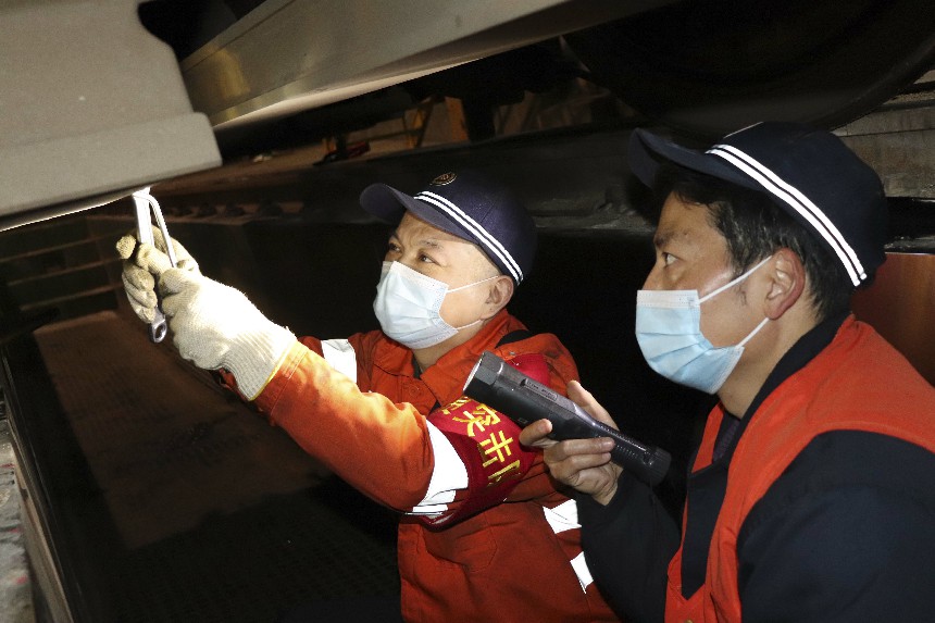 向塘機務段檢修黨員突擊隊員正在維修電力機車車底部件。徐云龍 攝