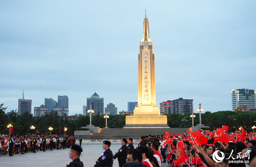 來(lái)自四面八方的游客和市民齊聚八一廣場(chǎng)，帶著滿腔熱情觀看升旗儀式。人民網(wǎng)記者 毛思遠(yuǎn)攝